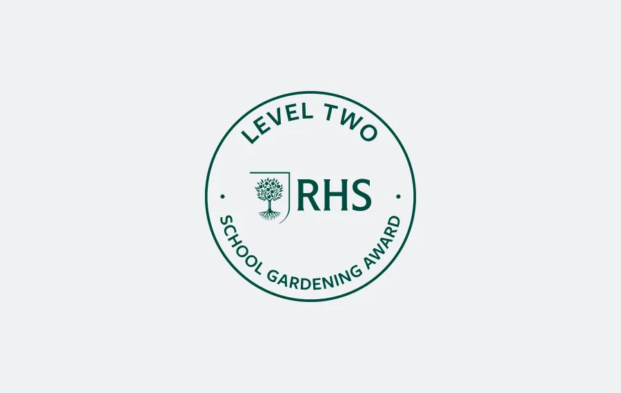 Round RHS Level Two School Gardening Award badge with tree emblem in centre.
