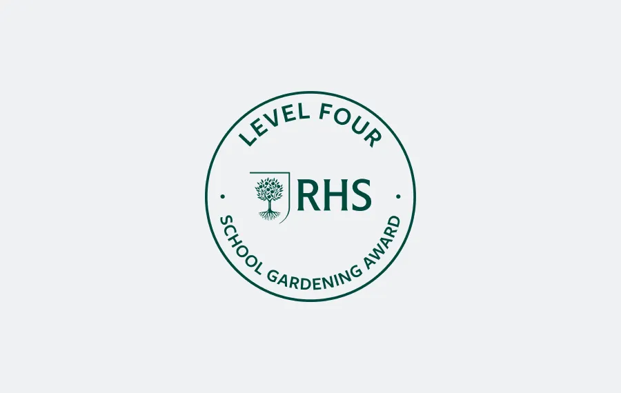 Round RHS Level Four School Gardening Award badge with tree emblem in centre.